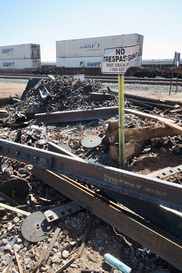 a train track with a no trespass sign in the middle of it