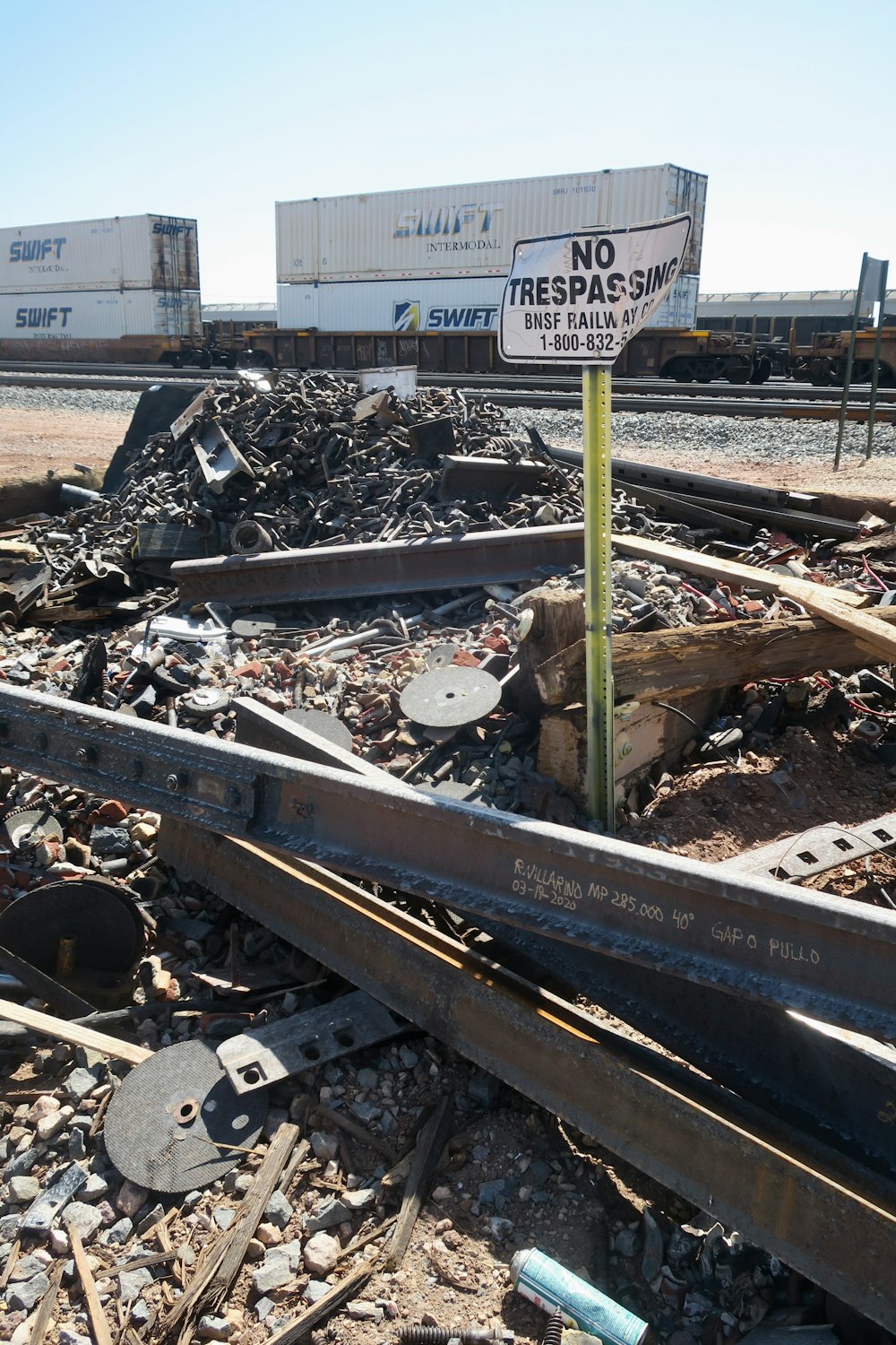 a train track with a no trespass sign in the middle of it