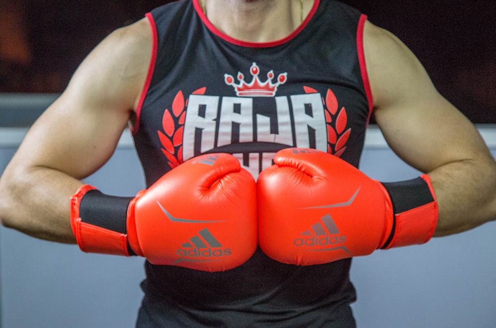 a man wearing red boxing gloves and a crown