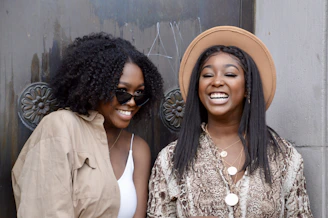 two women standing next to each other smiling