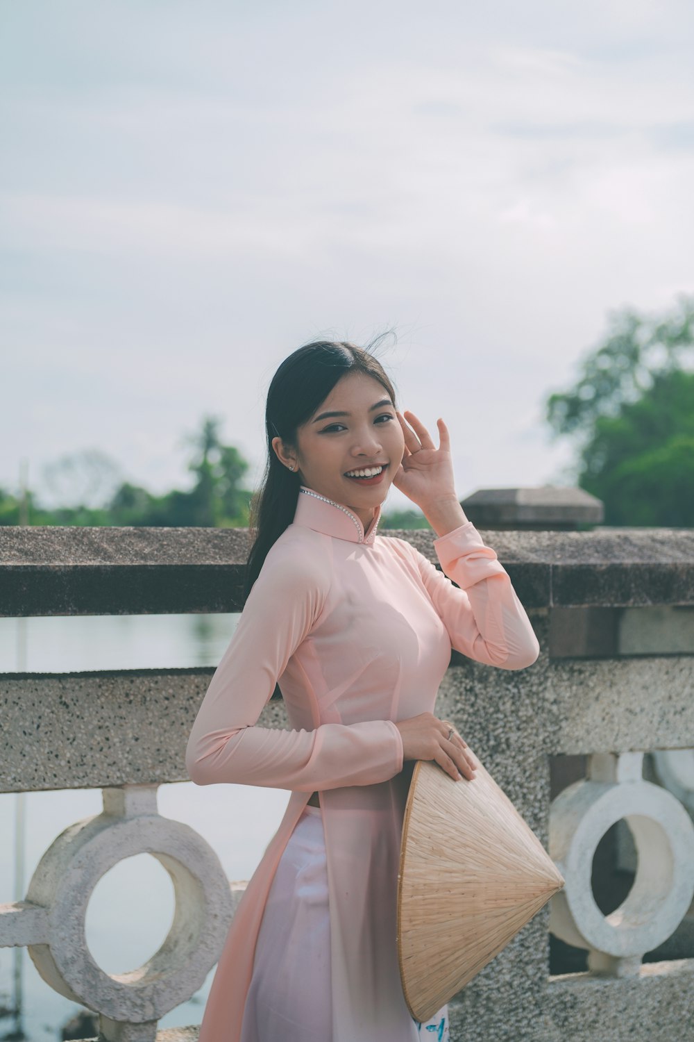 a woman in a pink dress posing for a picture