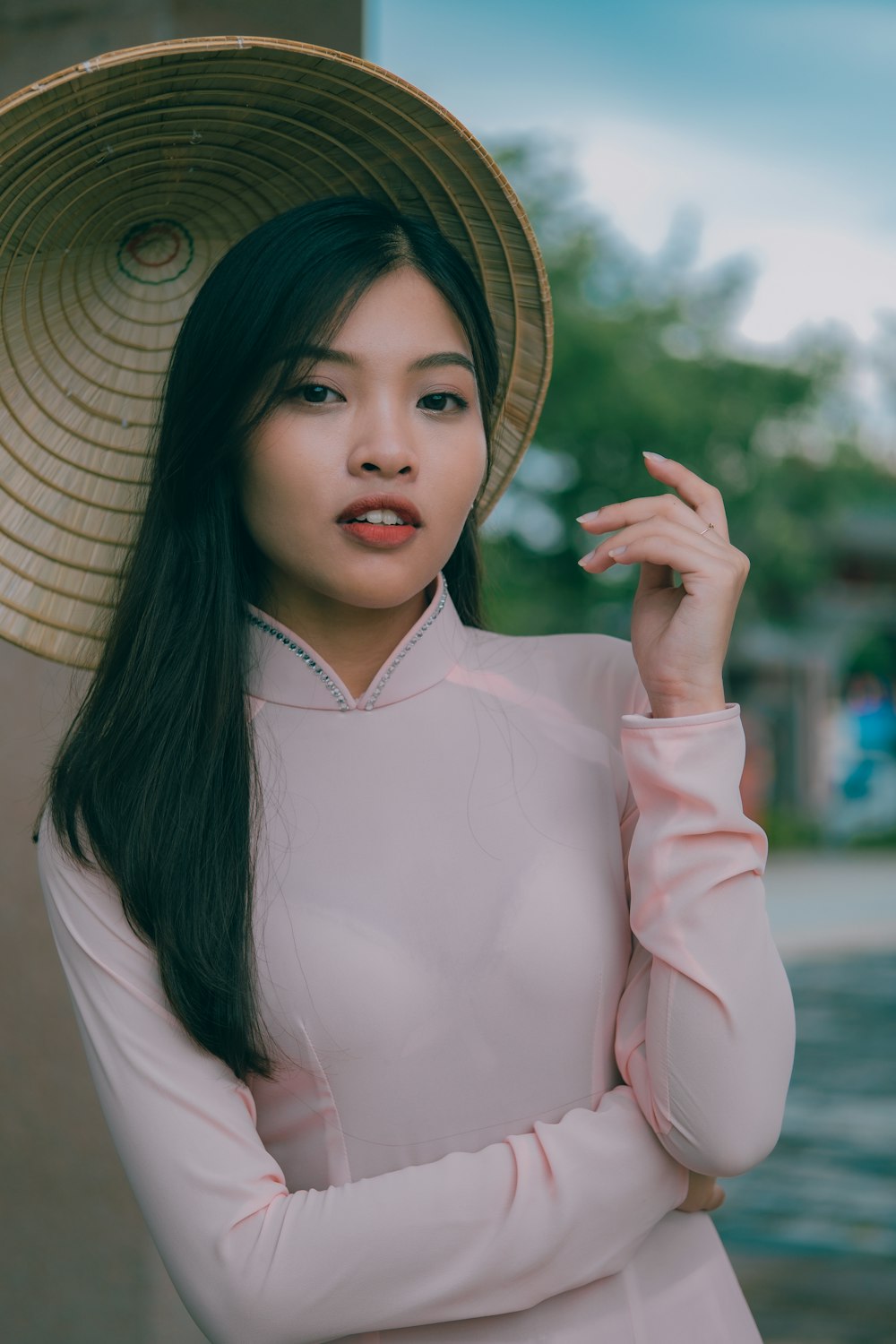 a woman in a hat poses for a picture