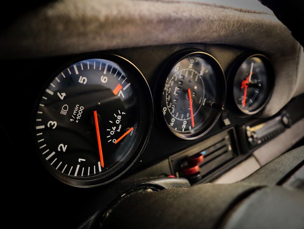 a close up of a speedometer and gauges in a car
