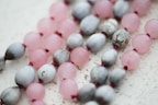 Close-up of premium beads in soft pastel colors with delicate daisy accents.