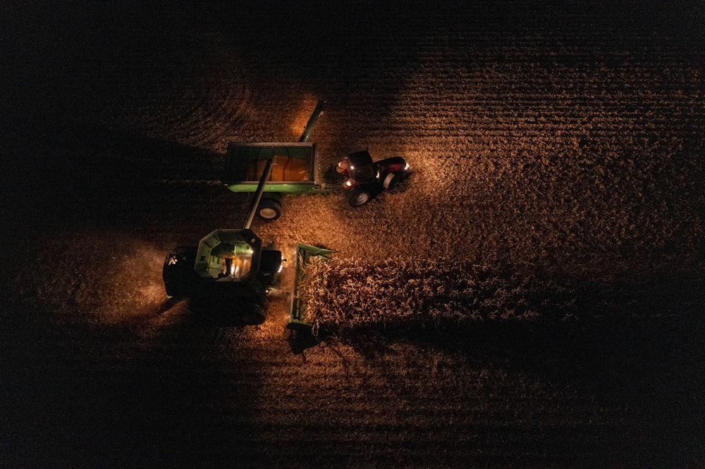 a tractor in the middle of a field at night