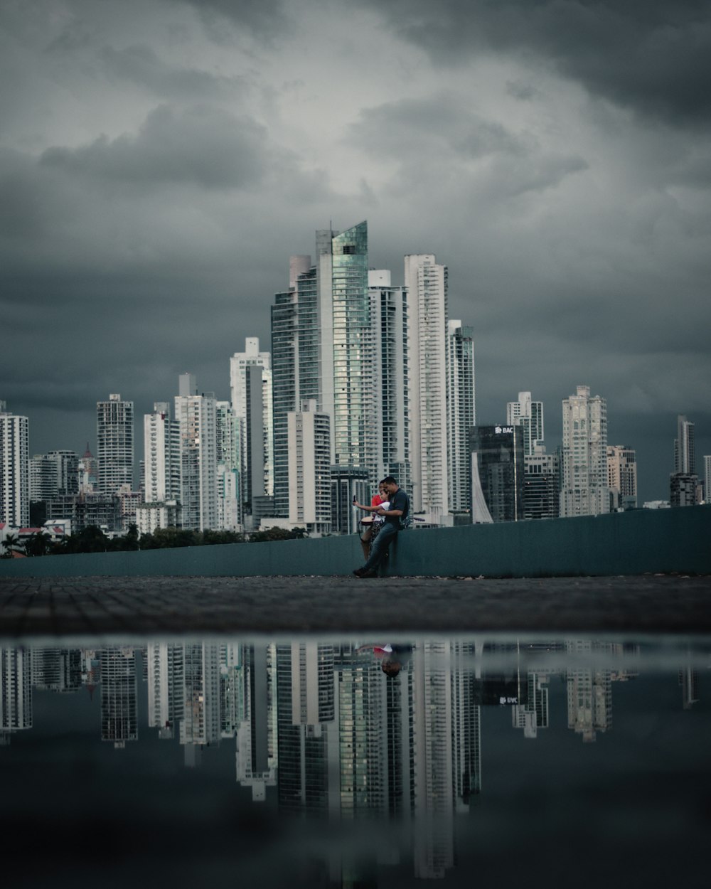 a couple kissing in front of a city skyline