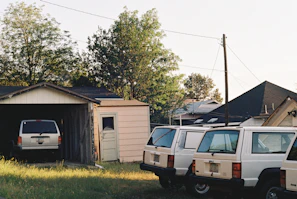 Family loading groceries into a spacious hybrid vehicle in a suburban neighborhood