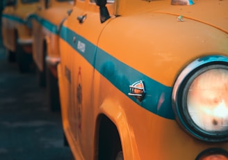 a row of yellow taxi cabs parked next to each other