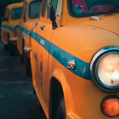 a row of yellow taxi cabs parked next to each other