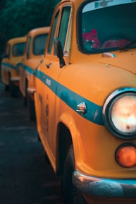 a row of yellow taxi cabs parked next to each other