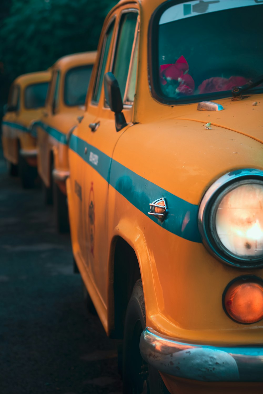 a row of yellow taxi cabs parked next to each other