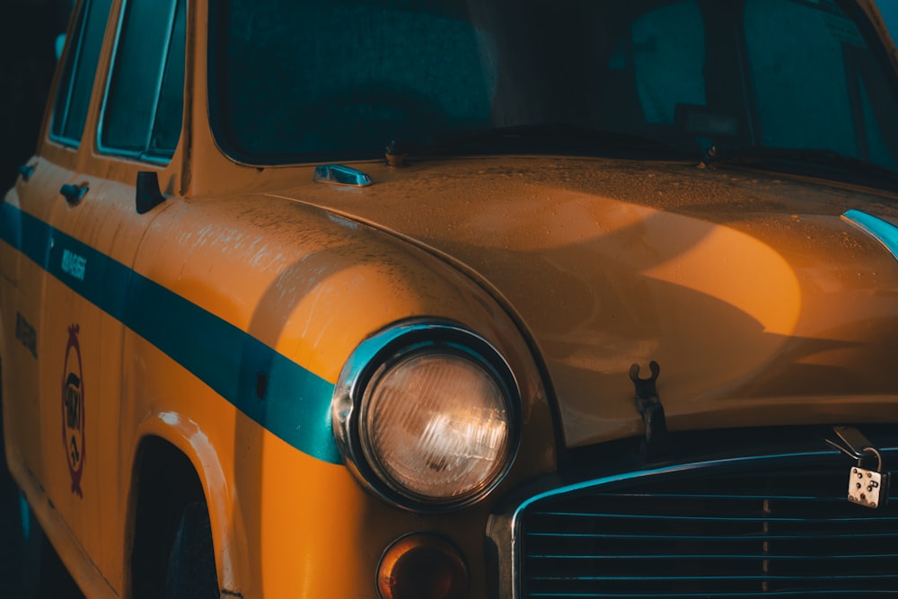 a close up of the front of a yellow taxi