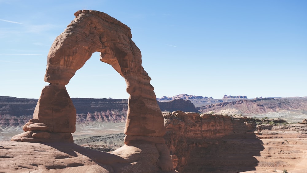 a close up of a rock mountain with Arches National Park in the background