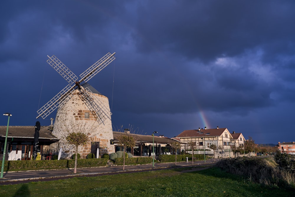 a windmill with a rainbow in the background