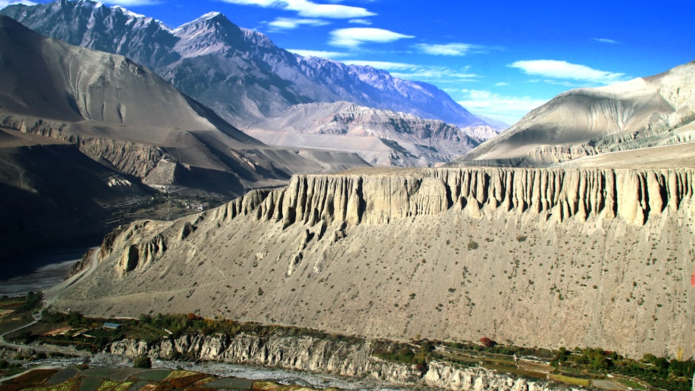 a view of a valley with mountains in the background