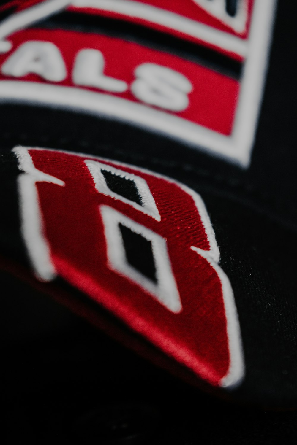 a close up of a baseball cap with a logo on it