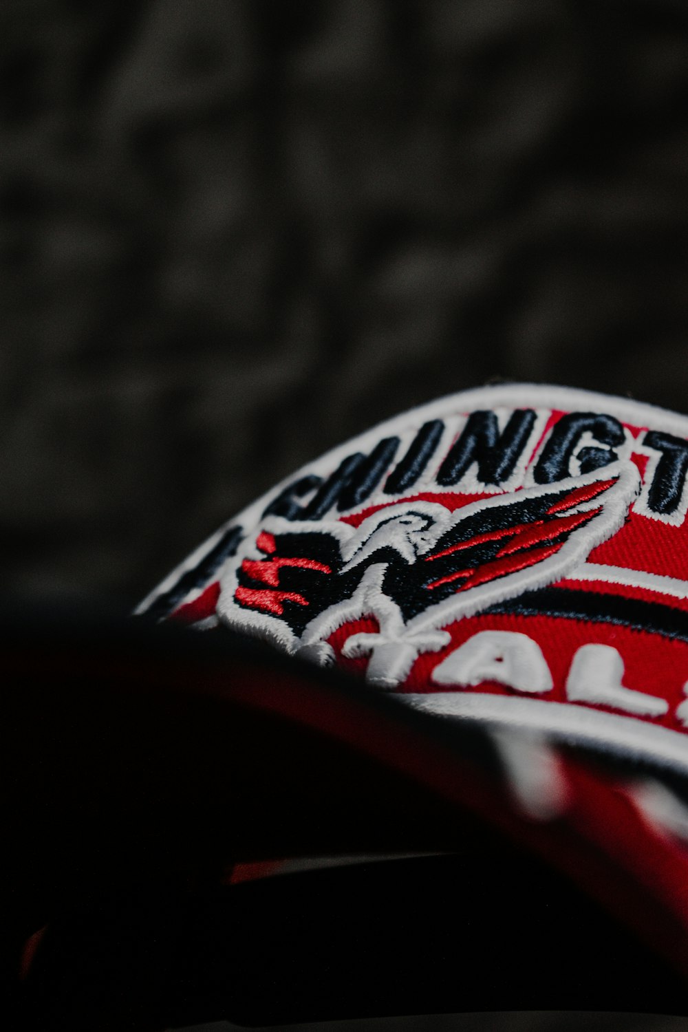 a close up of a red and white baseball cap