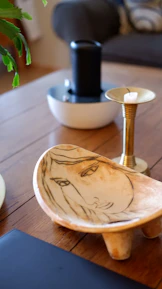 Close-up of a decorative bowl holding keys and small essentials on a sleek console table.