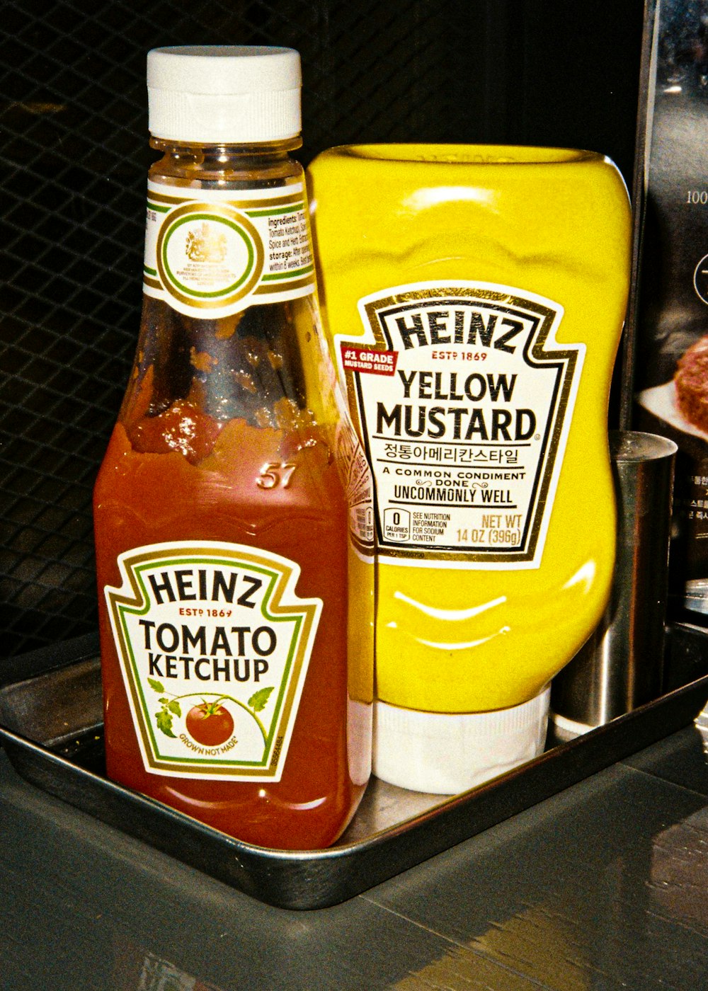a bottle of ketchup and a container of mustard