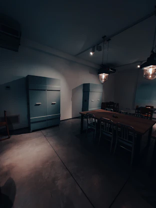 A sleek, dimly lit studio space with warm gold and steel blue lighting highlighting minimalist Norse-inspired decor.
