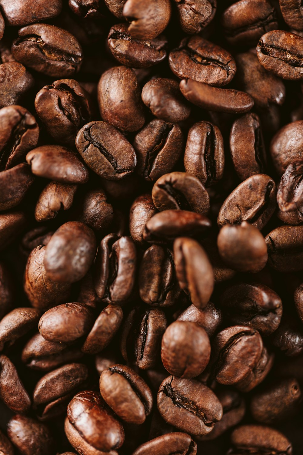 a pile of coffee beans sitting on top of each other