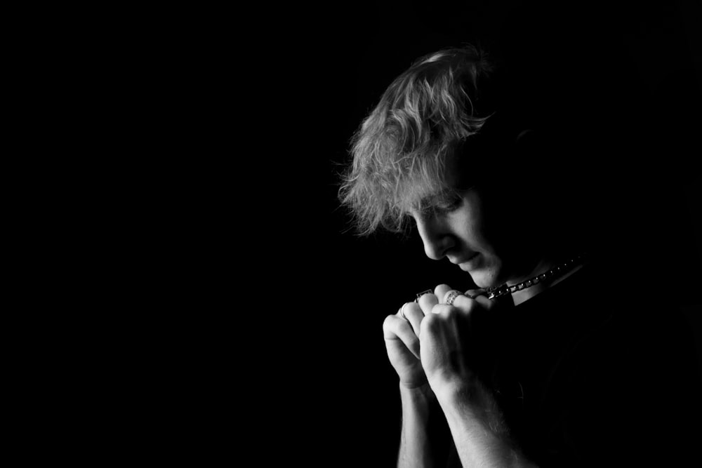 a black and white photo of a woman praying