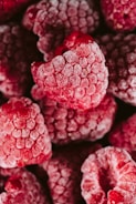a pile of raspberries covered in powdered sugar