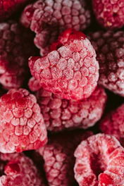 a pile of raspberries covered in powdered sugar