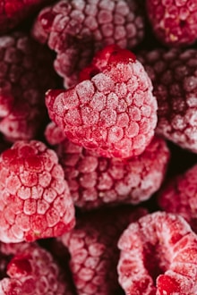 a pile of raspberries covered in powdered sugar