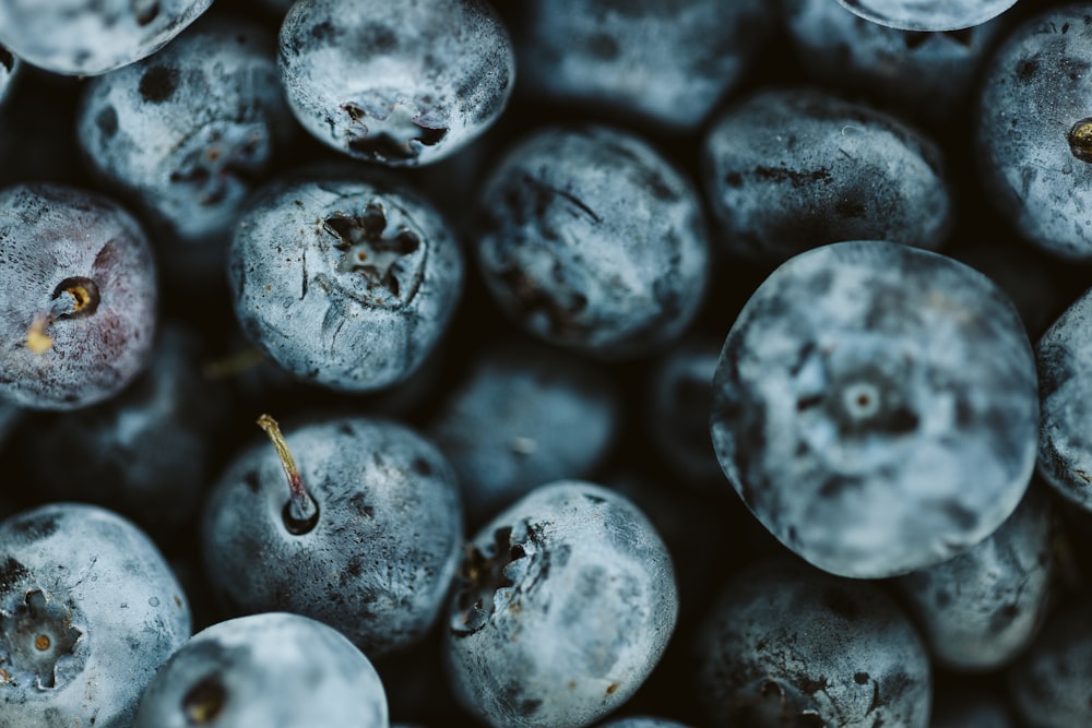 a pile of blueberries that are sitting on a table