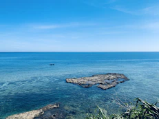 a body of water with rocks in the middle of it