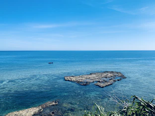 a body of water with rocks in the middle of it