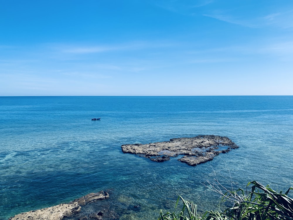 a body of water with rocks in the middle of it