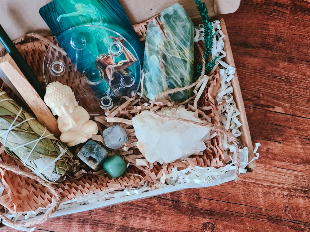 a wicker box filled with different items on top of a wooden floor