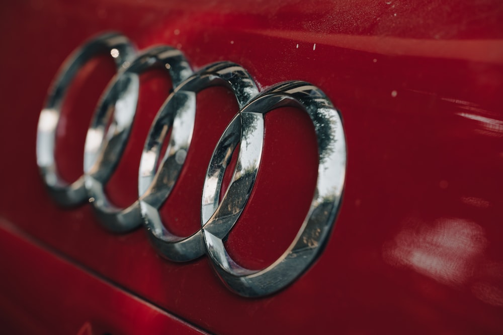 a close up of the emblem on a red car