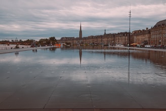 a large body of water with a clock tower in the background