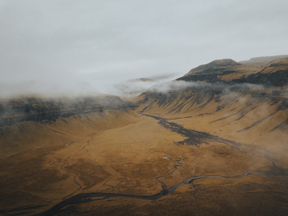 an aerial view of a valley with a river running through it