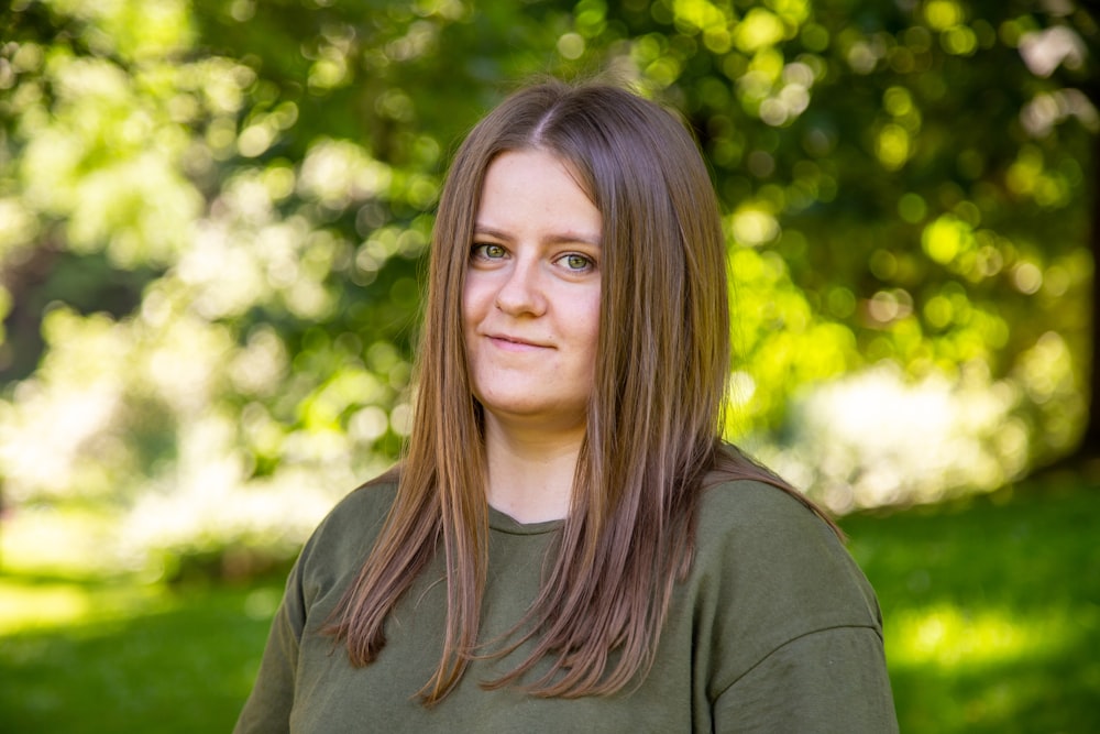 a woman in a green shirt posing for a picture