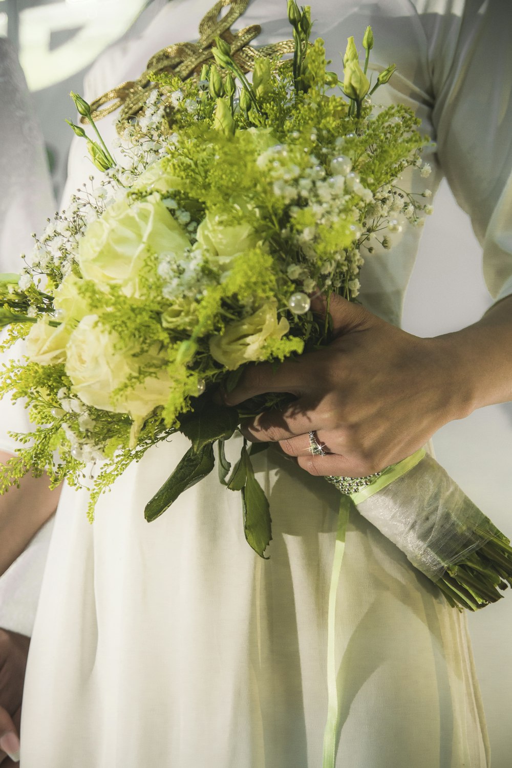 a woman holding a bouquet of flowers in her hands