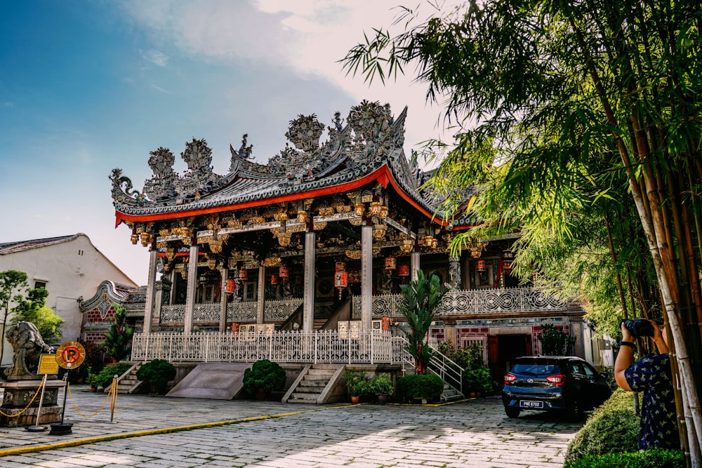 a chinese building with a car parked in front of it