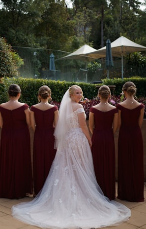 a bride and her bridesmaids standing together