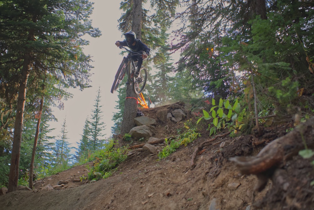 a person on a bike jumping over a hill