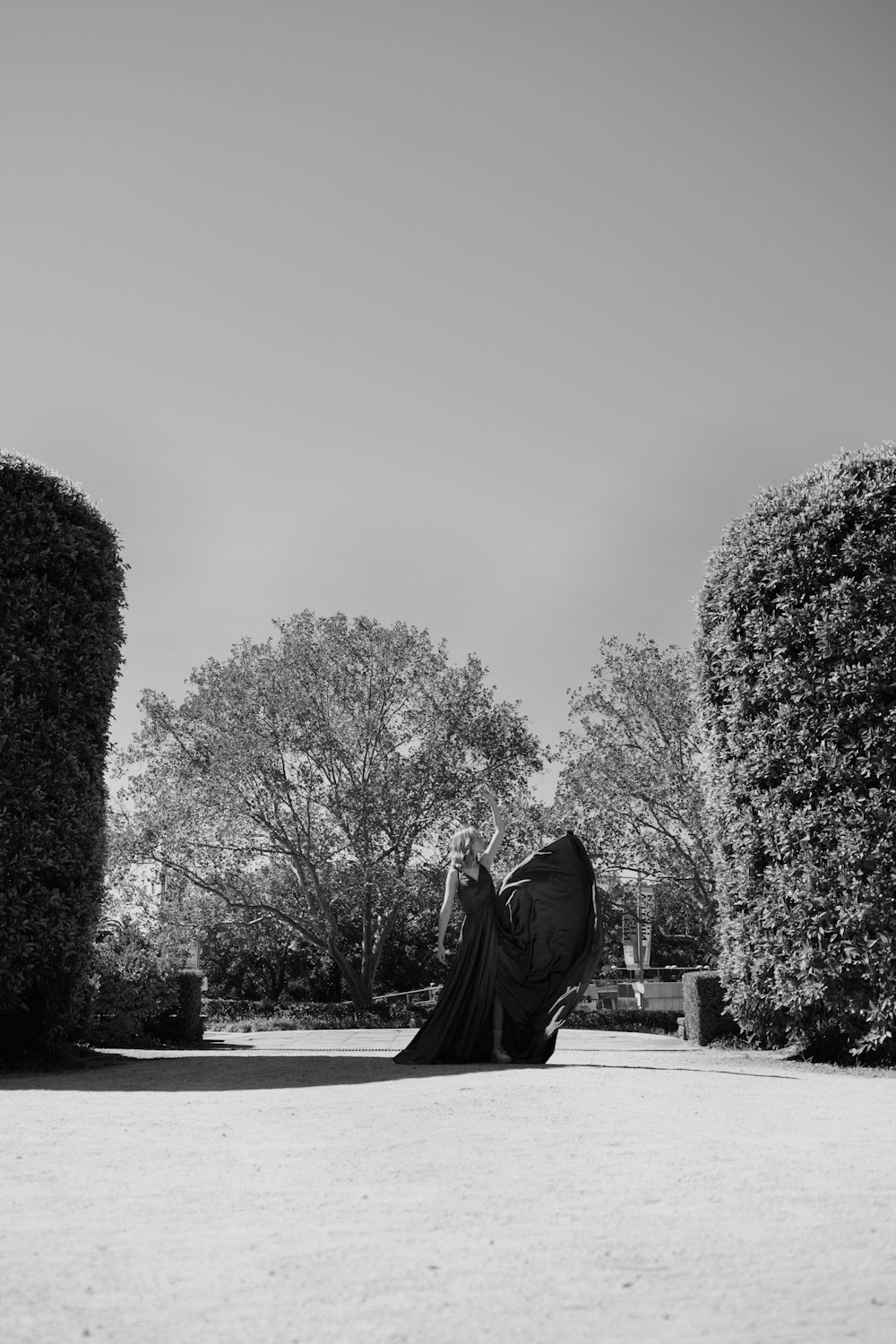 a woman sitting on the ground in a park