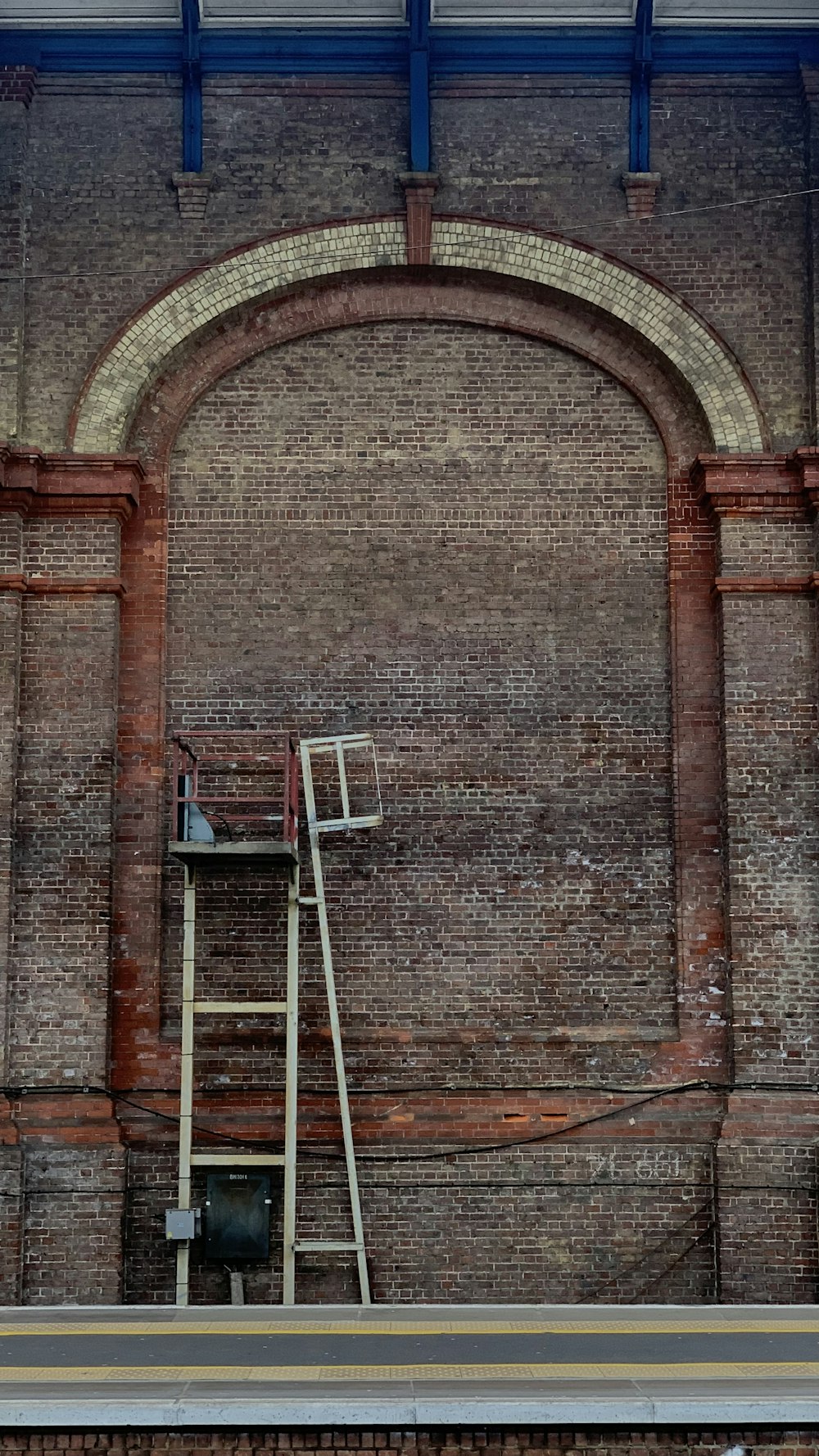 a ladder leaning up against a brick wall
