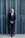 a man in a suit leaning against a wall