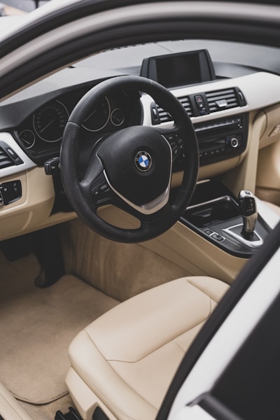 the interior of a car with a steering wheel and dashboard