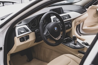 the interior of a car with a steering wheel and dashboard