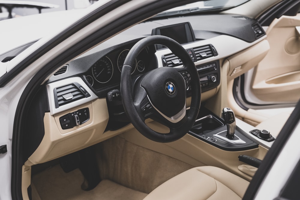 the interior of a car with a steering wheel and dashboard