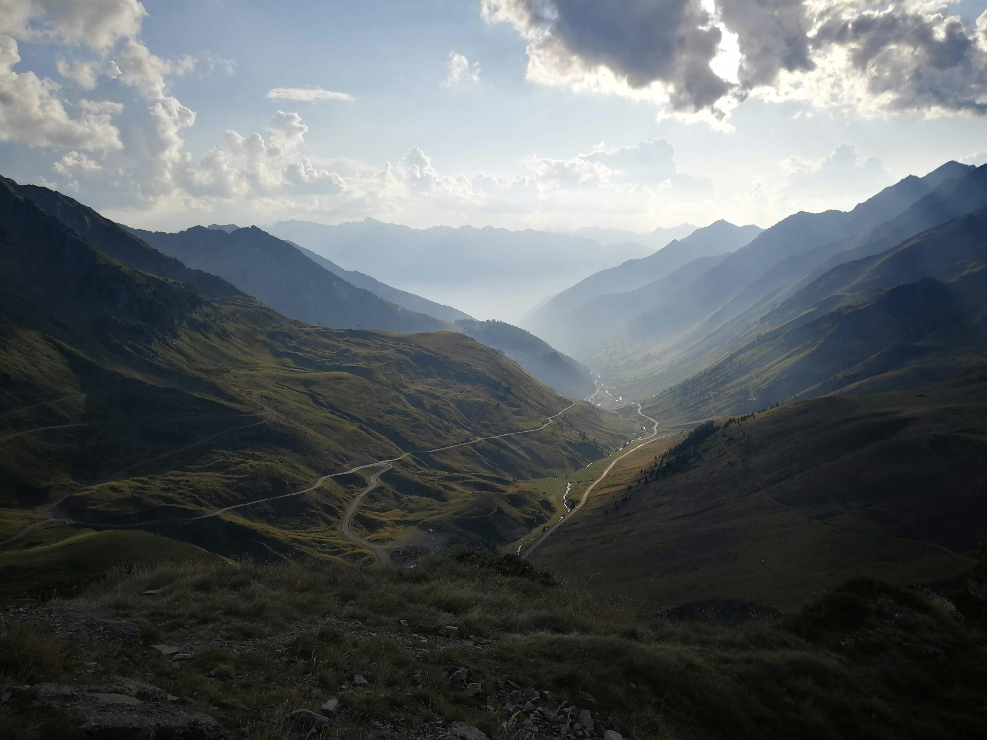 a view of a valley with mountains in the background