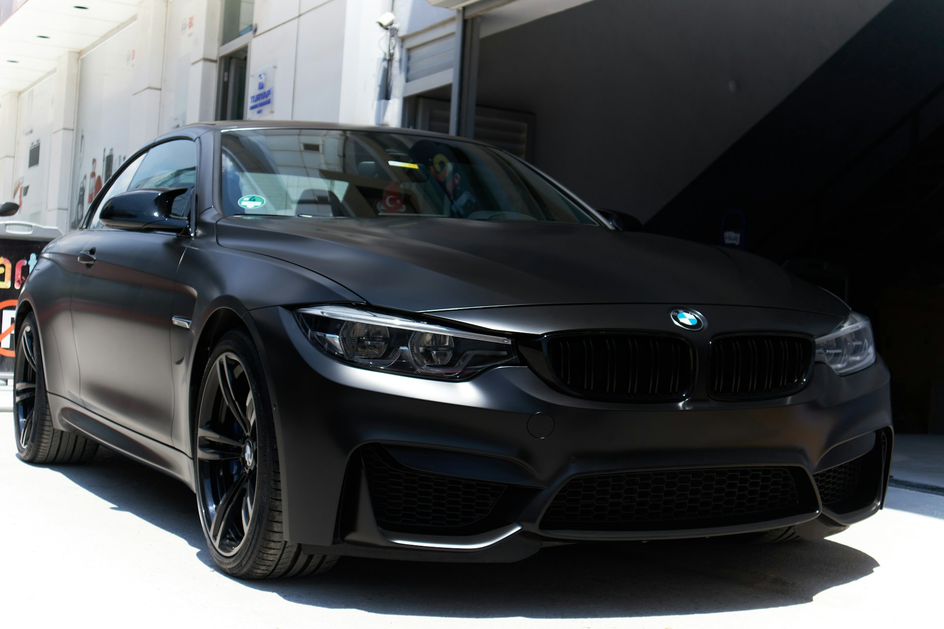 a black car parked in front of a building